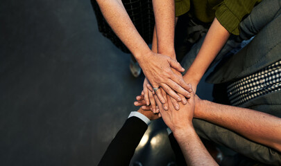 High angle view of business team stacking hands