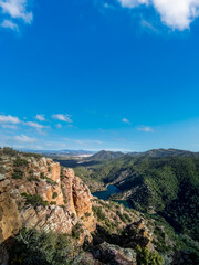 Rocks with layers, mountain range and dam