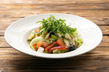 Vegetarian Greek salad with arugula, olives and feta cheese