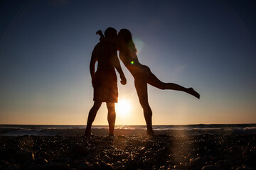 Beautiful young couple on the beach. Honeymoon. Sunset