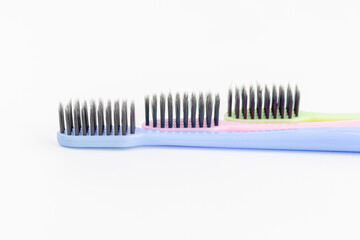 Colorful toothbrushes on a white background. Close-up. Soft Focus