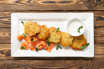 Draniki with pickled salmon and sour cream