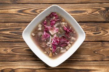 Broth with bacon and radicchio salad