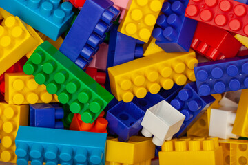 A colorful constructor set for children which lies on the plastic container