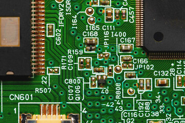 Green electronic board with radioelements close-up. Background for the theme of electronics and high tech equipment