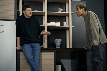 Staged photo illustrates problems and conflicts in gay couple relationships. Moment of showdown: two young men are arguing and proving something to each other.