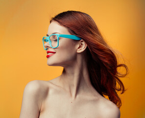 attractive woman naked shoulders red lips blue glasses studio