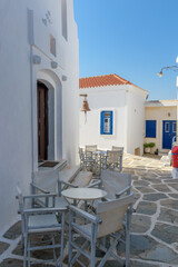Traditional Cycladitic alley with a narrow street   whitewashed houses and a church   in Chora kythnos, cyclades, Greece.