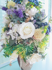 Big group of various flowers (rose, lily, another flower simulation) in a vase for love of couple or decoration