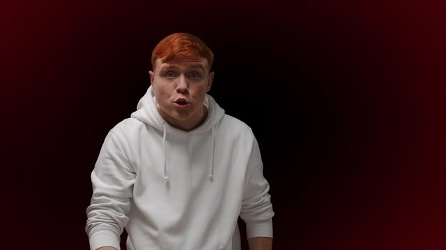 Aggressive red haired male scolding and gesturing with hands, angered hooligan