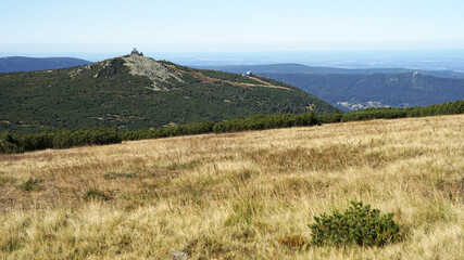 Szrenica Mountain hut panoramic view at Karkonosze Mountains summit landscape with grassy meadows and pine scrubs, touristic hiking concept, Poland