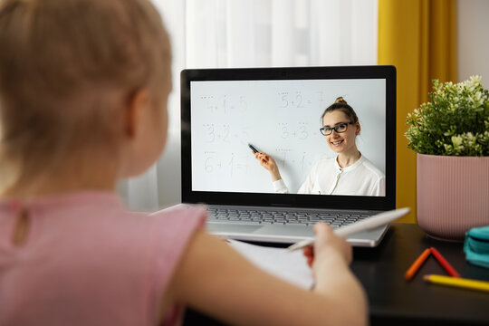 distance learning - primary school teacher explaining basic mathematics online. little girl using laptop at home. math lesson
