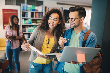 Group of college students studying in the school library.
