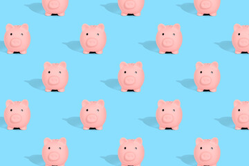 . Pattern of pink piggy banks on a blue background. Financial savings concept