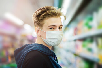 Boy wears protected mask in store. Shopping time during coronavirus outbreak.Boy in a medical mask. Quarantine and protection virus, flu, epidemic COVID-19. Coronavirus quarantine.