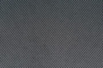 Black synthetic textile furniture upholstery mesh. Background with holes textured pattern.