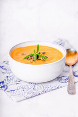 Pumpkin diet soup puree with pumpkin seeds and rosemary