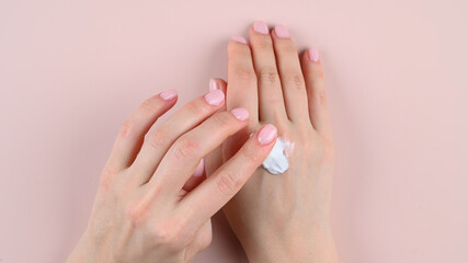 Girl smears hand cream, top view