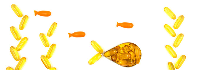 Omega-3 fish oil capsules in a shape of a fish on white background