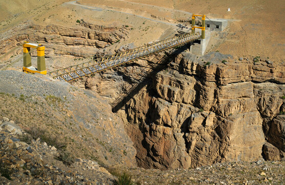 Suspension bridge over deep gorge in summer. Himachal Pradesh, India.