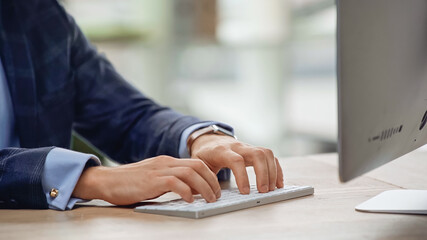 cropped view of manager typing on computer keyboard