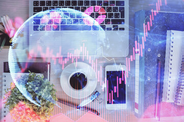 Obraz premium Double exposure of business theme hologram over desktop with phone. Top view. Mobile international trade connection concept.