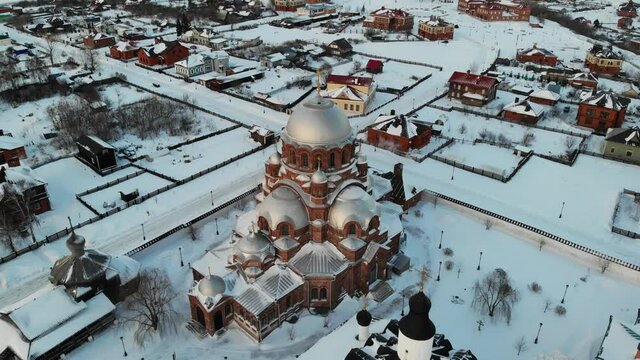 Nice flight two different orthodox churches at sunset. Winter. Sviyazhsk island. Small city village with Cathedral and Monastery Orthodox near Kazan Tatarstan UNESCO. Aerial view Flying over