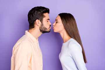 Profile side photo of young couple air kiss plump lips romantic date isolated on purple color background
