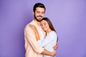 Photo of happy man and woman embrace good mood closed eyes nice smile isolated on violet color background