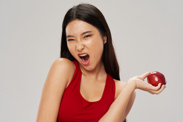Happy woman with apple in hand wide open mouth