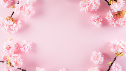 Fototapeta na wymiar Happy women's day concept, pink plum blossom frame on pastel background. Flat lay ,top view.