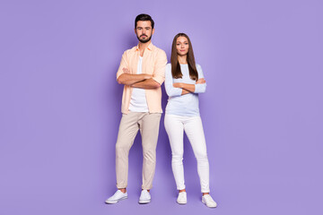 Fototapeta premium Full length photo of serious man and woman stand together confident folded hands isolated on purple color background