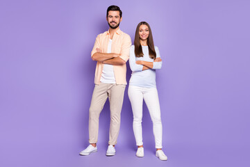 Full size photo of happy couple folded hands good mood wear white beige pants isolated on violet color background