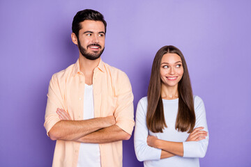 Photo of young cheerful couple happy positive smile crossed hands look empty space isolated over purple color background