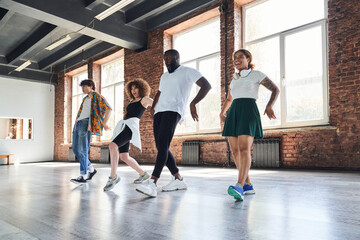 Cheerful young people during aerobics workout indoors