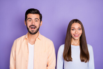Photo of amazed happy man and woman spouses surprised discount novelty isolated on violet color background