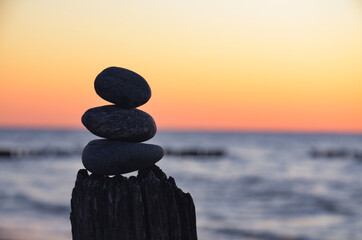  Rocks on the beach at sunset.
