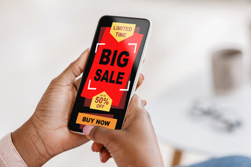 African american woman using mobile shopping application on smartphone