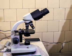 Microscope and partings on the table in the laboratory. Study on GMOs and Microbiology.