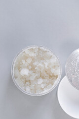 Fototapeta na wymiar Face Skin Scrub sample and container with scrub on light background.