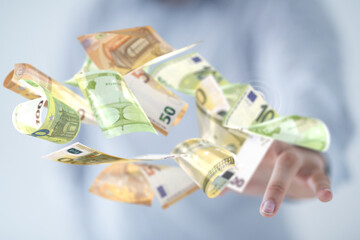 euro bills flying around  in hand