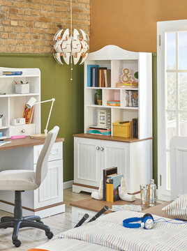 White wooden child room furniture decoration set, cabinet book and toy with working table.