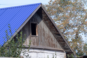 Fototapeta na wymiar House roof against the blue sky.