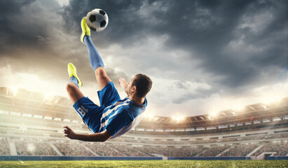 Male football or soccer player at stadium in flashlight. Young male sportive model training. Moment of attacking, catching. Concept of sport, competition, winning, action, motion, overcoming. Flyer. - Powered by Adobe