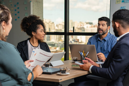 senior man sharing thoughts and ideas with the team in the office. .