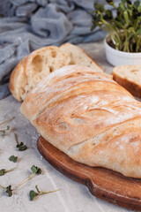 Sliced ciabatta bread on grey background. Italian white bread. Top view.