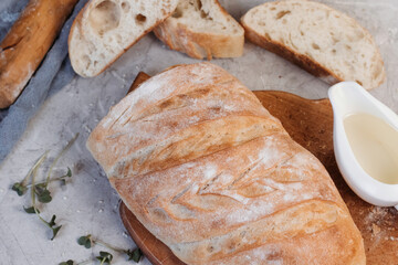 Sliced ciabatta bread on grey background. Italian white bread. Top view.