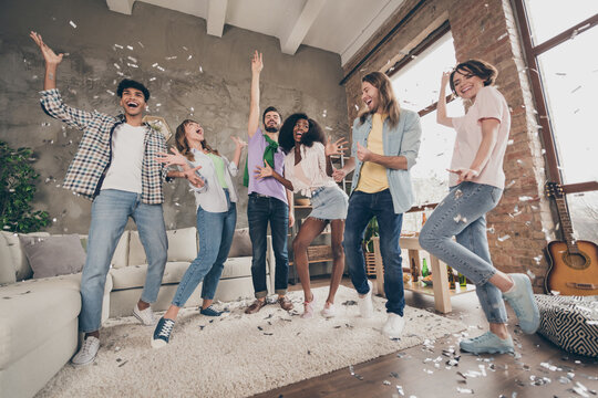 Full body photo of cheerful friend boyfriend girlfriend party at dormitory confetti fly indoors inside house home
