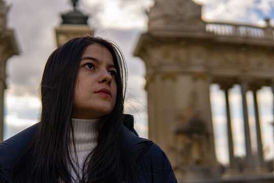 Portrait of young Colombian girl with antique architecture in the background