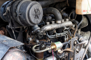 Close up pipes and old Loader car diesel engine. Car old engine part. The powerful engine of a car.